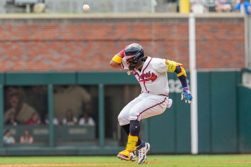 Aug 2, 2023; Cumberland, Georgia, USA; Atlanta Braves outfielder Ronald Acuna Jr. (13) ducks from a throw from the outfield after hitting a double against the Los Angeles Angels during the eighth inning at Truist Park. Mandatory Credit: Dale Zanine-USA TODAY Sports