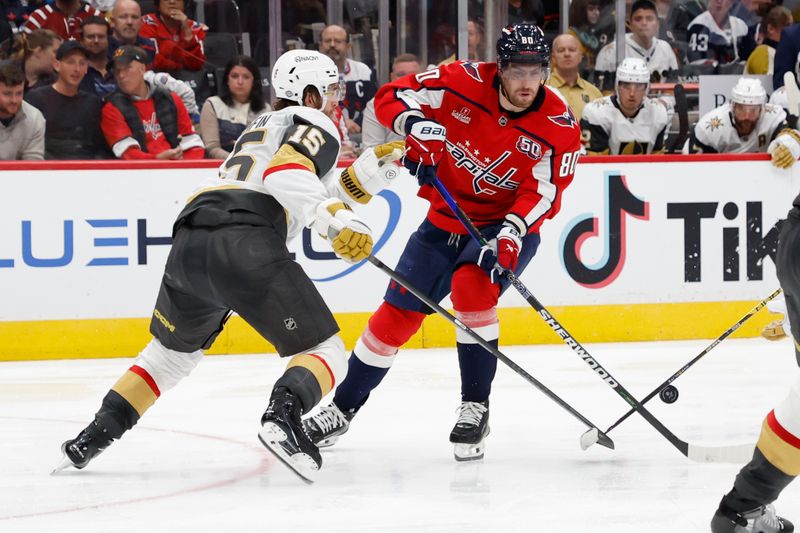 Oct 15, 2024; Washington, District of Columbia, USA; Washington Capitals left wing Pierre-Luc Dubois (80) skates with the puck as Vegas Golden Knights defenseman Noah Hanifin (15) defends in the third period at Capital One Arena. Mandatory Credit: Geoff Burke-Imagn Images