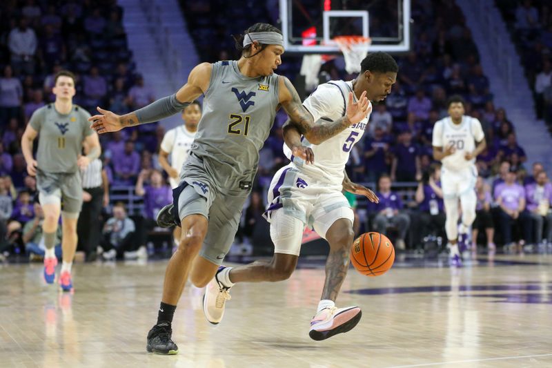 Feb 26, 2024; Manhattan, Kansas, USA; West Virginia Mountaineers guard RaeQuan Battle (21) and Kansas State Wildcats guard Cam Carter (5) go after a loose ball during the first half at Bramlage Coliseum. Mandatory Credit: Scott Sewell-USA TODAY Sports