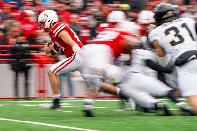 Oct 28, 2023; Lincoln, Nebraska, USA; Nebraska Cornhuskers quarterback Heinrich Haarberg (10) runs against the Purdue Boilermakers during the second quarter at Memorial Stadium. Mandatory Credit: Dylan Widger-USA TODAY Sports