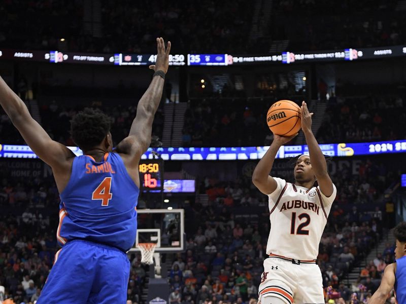 Mar 17, 2024; Nashville, TN, USA;  Auburn Tigers guard Denver Jones (12) shoots against Florida Gators guard Zyon Pullin (0) and forward Tyrese Samuel (4) in the second half in the SEC Tournament championship game at Bridgestone Arena. Mandatory Credit: Steve Roberts-USA TODAY Sports