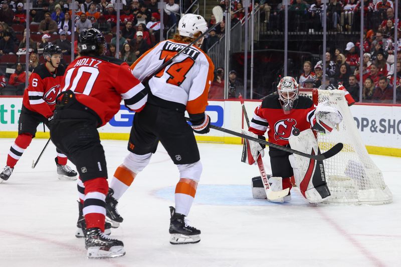 Dec 19, 2023; Newark, New Jersey, USA; New Jersey Devils goaltender Vitek Vanecek (41) makes a save on Philadelphia Flyers right wing Owen Tippett (74) during the first period at Prudential Center. Mandatory Credit: Ed Mulholland-USA TODAY Sports