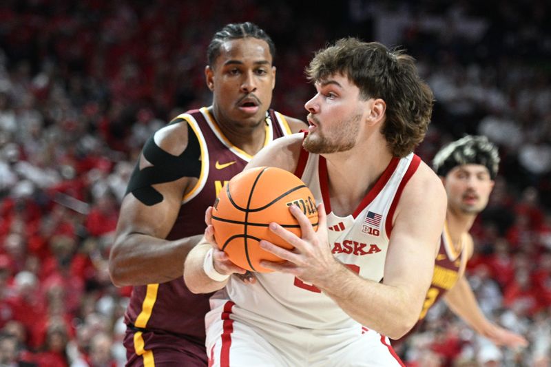 Mar 1, 2025; Lincoln, Nebraska, USA;  Nebraska Cornhuskers forward Andrew Morgan (23) looks to drive against Minnesota Golden Gophers forward Frank Mitchell (00) during the first half at Pinnacle Bank Arena. Mandatory Credit: Steven Branscombe-Imagn Images