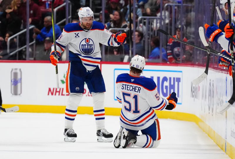 Nov 30, 2024; Denver, Colorado, USA; Edmonton Oilers defenseman Troy Stecher (51) celebrates his goal with center Leon Draisaitl (29) in the second period against the Colorado Avalanche at Ball Arena. Mandatory Credit: Ron Chenoy-Imagn Images