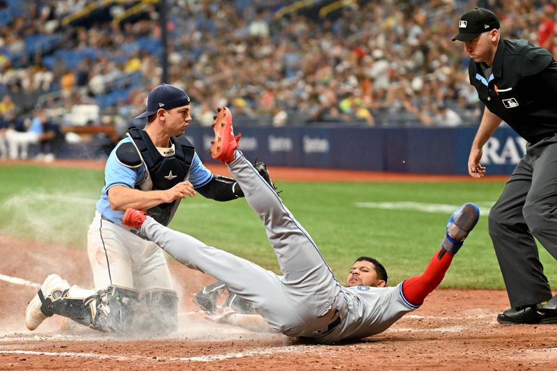 Sep 22, 2024; St. Petersburg, Florida, USA; Tampa Bay Rays catcher Ben Rortvedt (30) tags out Toronto Blue Jays center fielder Jonatan Clase (8) in the sixth inning at Tropicana Field. Mandatory Credit: Jonathan Dyer-Imagn Images