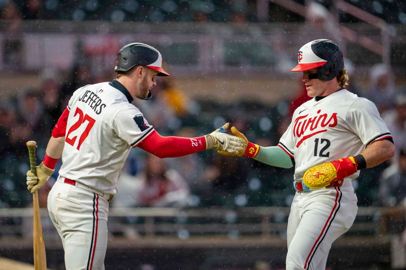 May 19, 2025; Minneapolis, Minnesota, USA; Minnesota Twins center fielder Harrison Bader (12) celebrates with catcher Ryan Jeffers (27) after scoring a run against the Cleveland Guardians in the second inning  at Target Field. Mandatory Credit: Jesse Johnson-Imagn Images