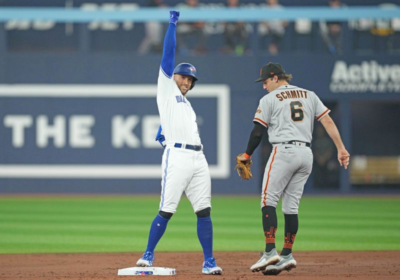 Jun 28, 2023; Toronto, Ontario, CAN; Toronto Blue Jays right fielder George Springer (4) celebrates hitting a double against the San Francisco Giants during the first inning at Rogers Centre. Mandatory Credit: Nick Turchiaro-USA TODAY Sports