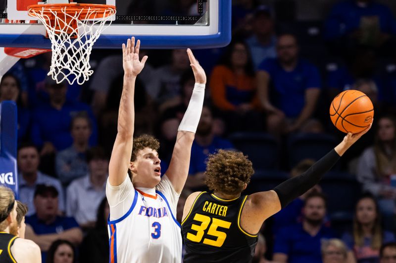 Feb 28, 2024; Gainesville, Florida, USA; Missouri Tigers forward Noah Carter (35) shoots over Florida Gators center Micah Handlogten (3) during the second half at Exactech Arena at the Stephen C. O'Connell Center. Mandatory Credit: Matt Pendleton-USA TODAY Sports