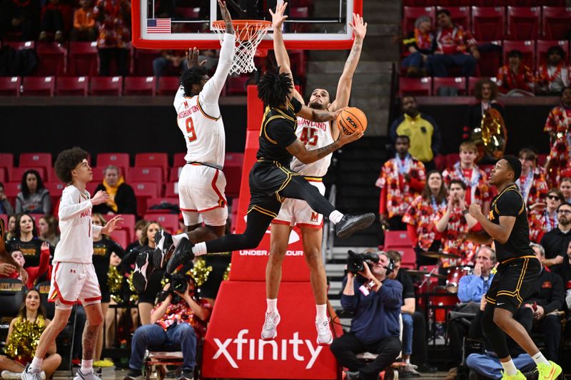 Feb 11, 2026; College Park, Maryland, USA;  Iowa Hawkeyes guard Tavion Banks (#6) attempts a shot around the defense of Maryland Terrapins forward Solomon Washington (9) and center Colin Metcalf (45) in the second half at Xfinity Center. Mandatory Credit: Jamie Sabau-Imagn Images