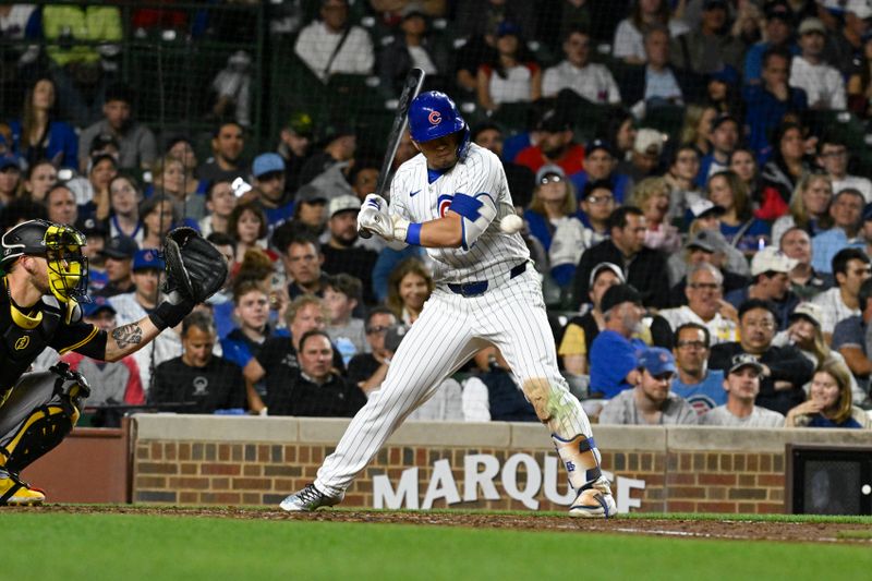 May 16, 2024; Chicago, Illinois, USA;  Chicago Cubs outfielder Seiya Suzuki (27) is hit by a pitch thrown by Pittsburgh Pirates pitcher Colin Holderman (35) during the eighth inning at Wrigley Field. Mandatory Credit: Matt Marton-USA TODAY Sports