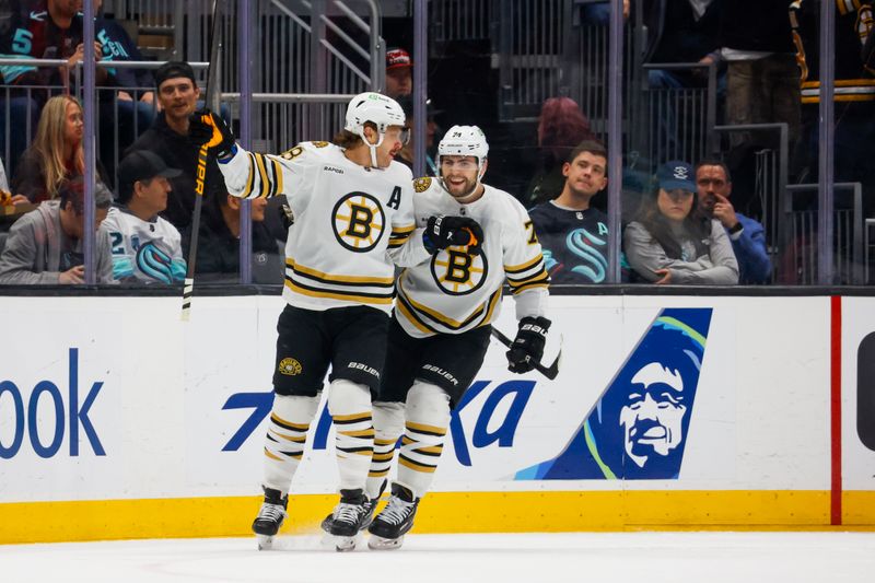 Feb 26, 2024; Seattle, Washington, USA; Boston Bruins right wing David Pastrnak (88) celebrates with left wing Jake DeBrusk (74) after scoring a goal against the Seattle Kraken during the first period at Climate Pledge Arena. Mandatory Credit: Joe Nicholson-USA TODAY Sports