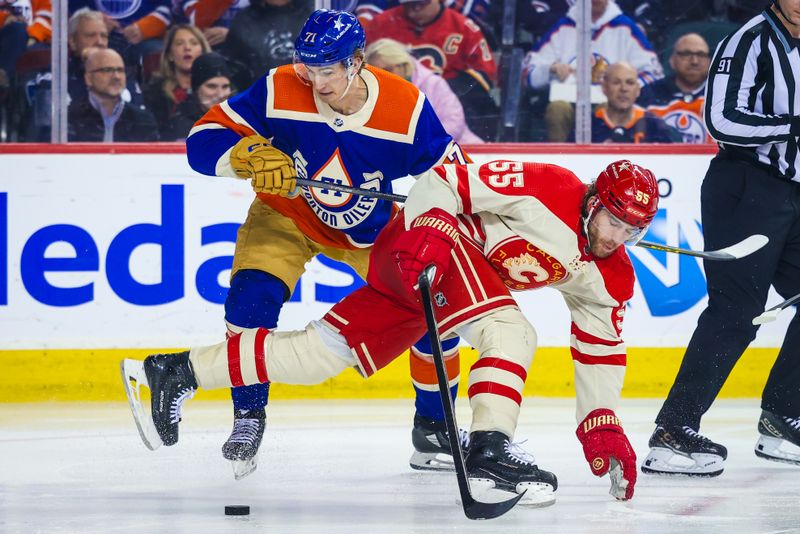 Jan 20, 2024; Calgary, Alberta, CAN; Edmonton Oilers center Ryan McLeod (71) and Calgary Flames defenseman Noah Hanifin (55) battles for the puck during the third period at Scotiabank Saddledome. Mandatory Credit: Sergei Belski-USA TODAY Sports