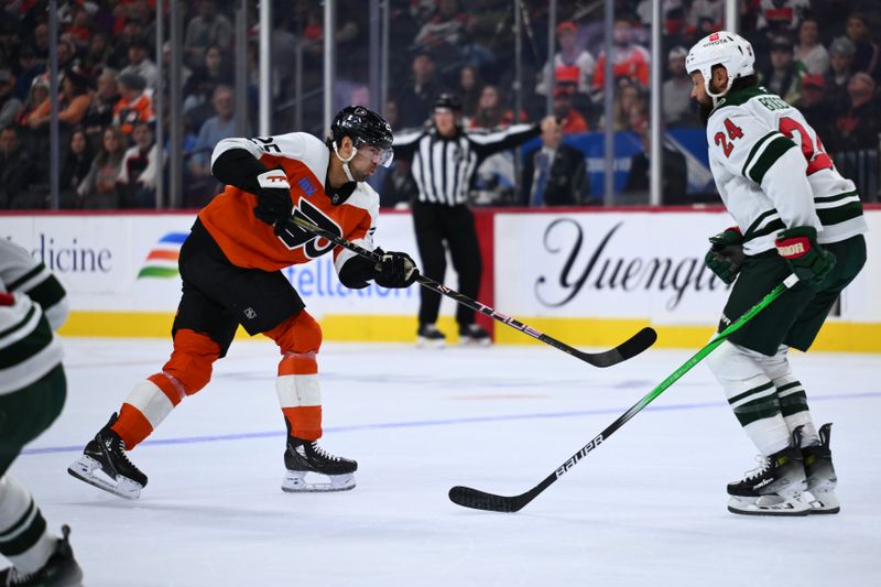 Oct 26, 2024; Philadelphia, Pennsylvania, USA; Philadelphia Flyers center Ryan Poehling (25) shoots against Minnesota Wild defenseman Zach Bogosian (24) in the first period at Wells Fargo Center. Mandatory Credit: Kyle Ross-Imagn Images