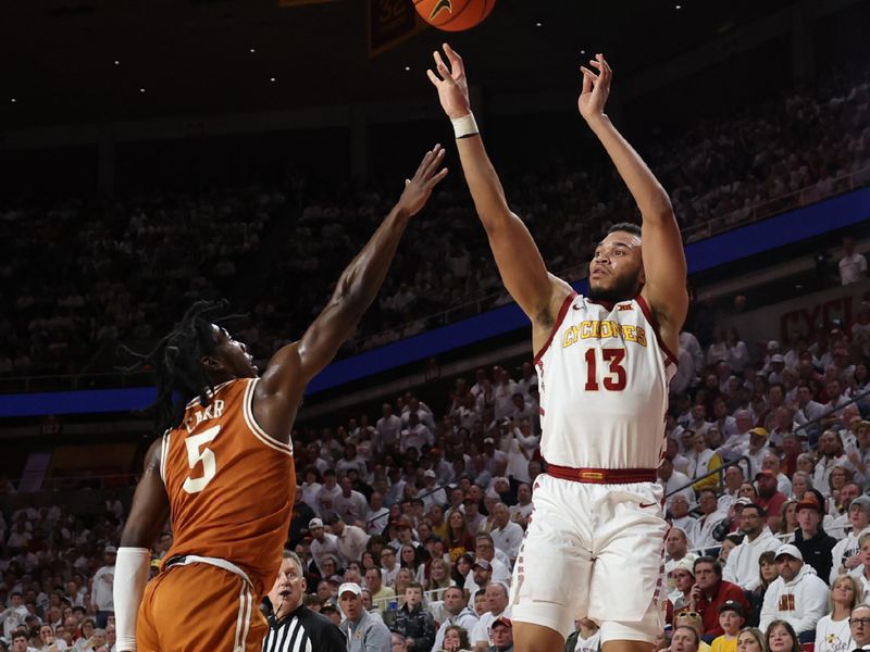 Jan 17, 2023; Ames, Iowa, USA; Iowa State Cyclones guard Jaren Holmes (13) shoots over Texas Longhorns guard Marcus Carr (5) in the first half at James H. Hilton Coliseum. Mandatory Credit: Reese Strickland-USA TODAY Sports