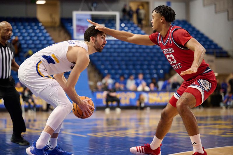 Feb 6, 2024; San Jose, California, USA; San Jose State Spartans forward Tibet Gorener (5) dribbles the ball against Fresno State Bulldogs guard Xavier DuSell (53) during the first half at Provident Credit Union Event Center. Mandatory Credit: Robert Edwards-USA TODAY Sports