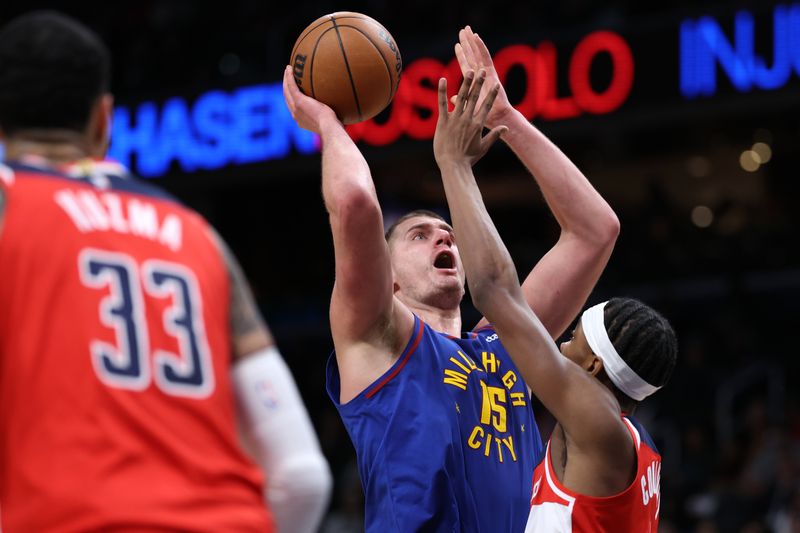 WASHINGTON, DC - JANUARY 21: Nikola Jokic #15 of the Denver Nuggets shoots in front of Bilal Coulibaly #0 of the Washington Wizards during the first half at Capital One Arena on January 21, 2024 in Washington, DC. NOTE TO USER: User expressly acknowledges and agrees that, by downloading and or using this photograph, User is consenting to the terms and conditions of the Getty Images License Agreement. (Photo by Patrick Smith/Getty Images)