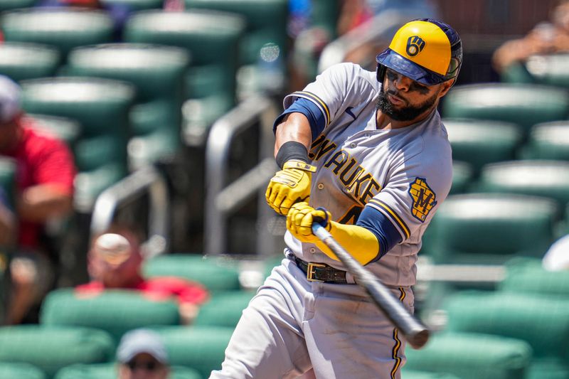 Jul 30, 2023; Cumberland, Georgia, USA; Milwaukee Brewers first baseman Carlos Santana (41) hits a home run against the Atlanta Braves during the third inning at Truist Park. Mandatory Credit: Dale Zanine-USA TODAY Sports