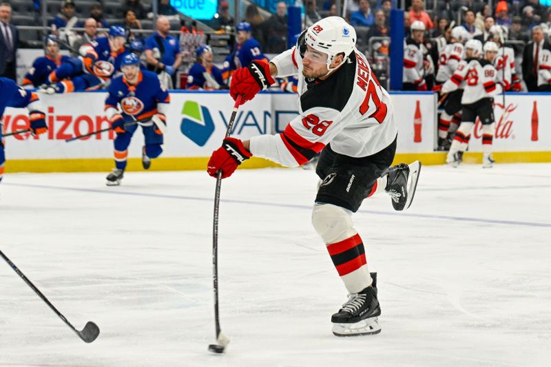 Dec 23, 2025; Elmont, New York, USA;  New Jersey Devils right wing Timo Meier (28) attempts a shot against the New York Islanders during the first period at UBS Arena. Mandatory Credit: Dennis Schneidler-Imagn Images