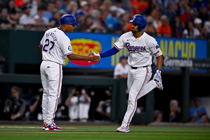 Aug 7, 2024; Arlington, Texas, USA;  Texas Rangers second baseman Marcus Semien (2) rounds the bases past third base coach Tony Beasley (27) after Semien hits a home run against the Houston Astros during the sixth inning at Globe Life Field. Mandatory Credit: Jerome Miron-USA TODAY Sports