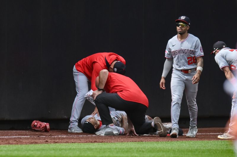 Sep 21, 2025; New York City, New York, USA; Washington Nationals outfielder Daylen Lile (51) receives medical attention after crashing into a wall during the third inning against the New York Mets at Citi Field. Mandatory Credit: John Jones-Imagn Images