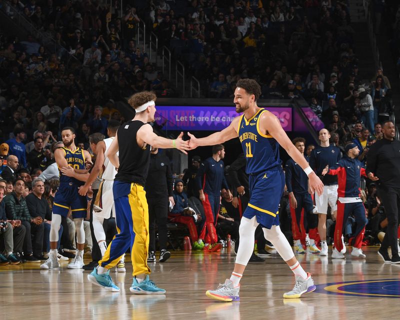 SAN FRANCISCO, CA - APRIL 12:  Brandin Podziemski #2 of the Golden State Warriors & Klay Thompson #11 of the Golden State Warriors high five during the game on April 12, 2024 at Chase Center in San Francisco, California. NOTE TO USER: User expressly acknowledges and agrees that, by downloading and or using this photograph, user is consenting to the terms and conditions of Getty Images License Agreement. Mandatory Copyright Notice: Copyright 2024 NBAE (Photo by Noah Graham/NBAE via Getty Images)