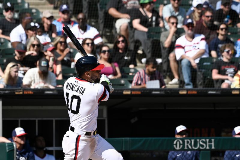 Aug 27, 2023; Chicago, Illinois, USA;  Chicago White Sox third baseman Yoan Moncada (10) hits a two-RBI double against the Oakland Athletics seventh inning at Guaranteed Rate Field. Mandatory Credit: Matt Marton-USA TODAY Sports