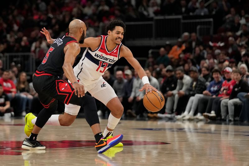 CHICAGO, ILLINOIS - MARCH 25: Jordan Poole #13 of the Washington Wizards dribbles the ball against Jevon Carter #5 of the Chicago Bulls during the first half at the United Center on March 25, 2024 in Chicago, Illinois. NOTE TO USER: User expressly acknowledges and agrees that, by downloading and or using this photograph, User is consenting to the terms and conditions of the Getty Images License Agreement. (Photo by Patrick McDermott/Getty Images)