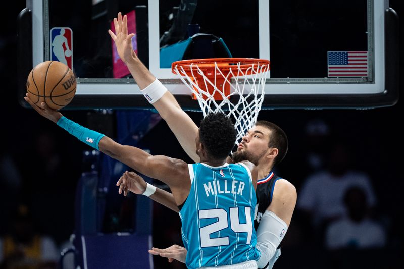 CHARLOTTE, NORTH CAROLINA - MARCH 31: Brandon Miller #24 of the Charlotte Hornets drives to the basket while guarded by Ivica Zubac #40 of the LA Clippers in the first quarter during their game at Spectrum Center on March 31, 2024 in Charlotte, North Carolina. NOTE TO USER: User expressly acknowledges and agrees that, by downloading and or using this photograph, User is consenting to the terms and conditions of the Getty Images License Agreement. (Photo by Jacob Kupferman/Getty Images)