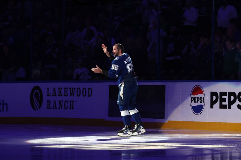 Oct 30, 2025; Tampa, Florida, USA; Tampa Bay Lightning right wing Nikita Kucherov (86) is celebrated before the game for 1000 points against the Dallas Stars at Benchmark International Arena. Mandatory Credit: Kim Klement Neitzel-Imagn Images