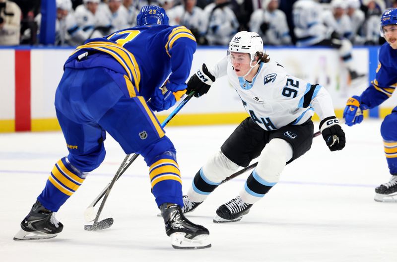 Nov 4, 2025; Buffalo, New York, USA;  Buffalo Sabres defenseman Mattias Samuelsson (23) knocks the puck off the stick of Utah Mammoth center Logan Cooley (92) during the first period at KeyBank Center. Mandatory Credit: Timothy T. Ludwig-Imagn Images