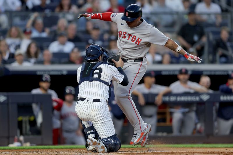 Jun 7, 2025; Bronx, New York, USA; New York Yankees catcher Austin Wells (28) tags out Boston Red Sox designated hitter Rafael Devers (11) trying to score on a fielders choice ground ball by catcher Carlos Narvaez (not pictured) during the third inning at Yankee Stadium. Mandatory Credit: Brad Penner-Imagn Images