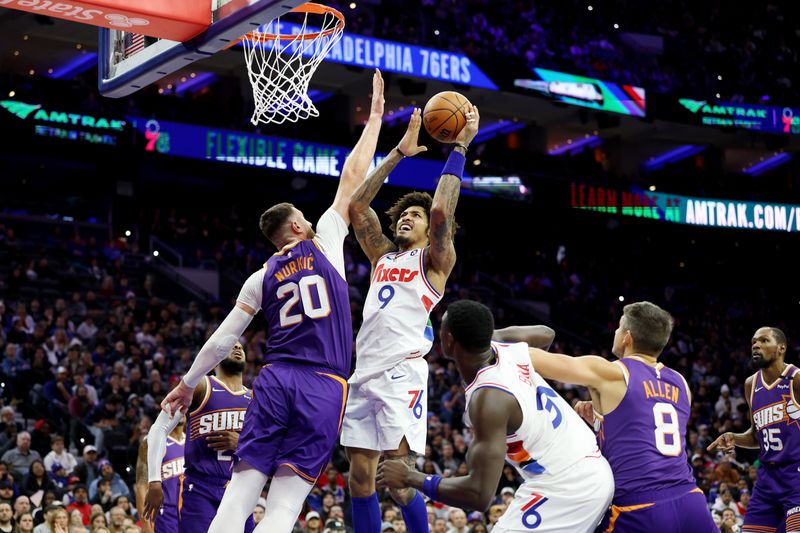 PHILADELPHIA, PENNSYLVANIA - JANUARY 06: Kelly Oubre Jr. #9 of the Philadelphia 76ers puts up a shot against Jusuf Nurkic #20 of the Phoenix Suns during the second half at the Wells Fargo Center on January 06, 2025 in Philadelphia, Pennsylvania. NOTE TO USER: User expressly acknowledges and agrees that, by downloading and or using this photograph, User is consenting to the terms and conditions of the Getty Images License Agreement. (Photo by Emilee Chinn/Getty Images)