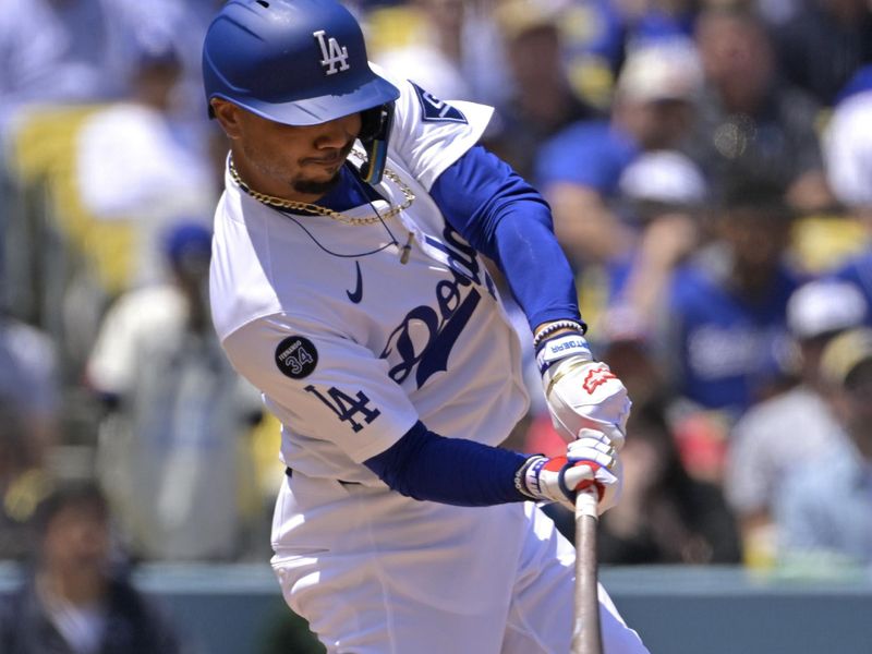 Apr 30, 2025; Los Angeles, California, USA;  Los Angeles Dodgers shortstop Mookie Betts (50) singles in two runs in the third inning against the Miami Marlins at Dodger Stadium. Mandatory Credit: Jayne Kamin-Oncea-Imagn Images