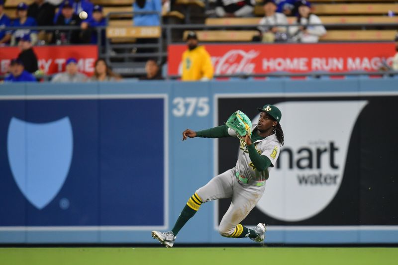 May 13, 2025; Los Angeles, California, USA; Athletics right fielder Lawrence Butler (4) catches the fly ball of Los Angeles Dodgers center fielder Chris Taylor (3) during the ninth inning at Dodger Stadium. Mandatory Credit: Gary A. Vasquez-Imagn Images