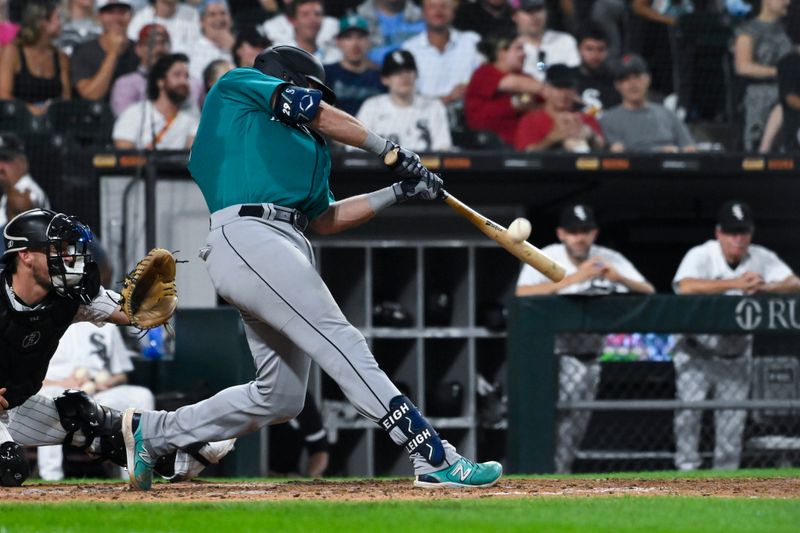 Aug 22, 2023; Chicago, Illinois, USA; Seattle Mariners catcher Cal Raleigh (29) hits an RBI sacrifice fly ball against the Chicago White Sox during the sixth inning at Guaranteed Rate Field. Mandatory Credit: Matt Marton-USA TODAY Sports