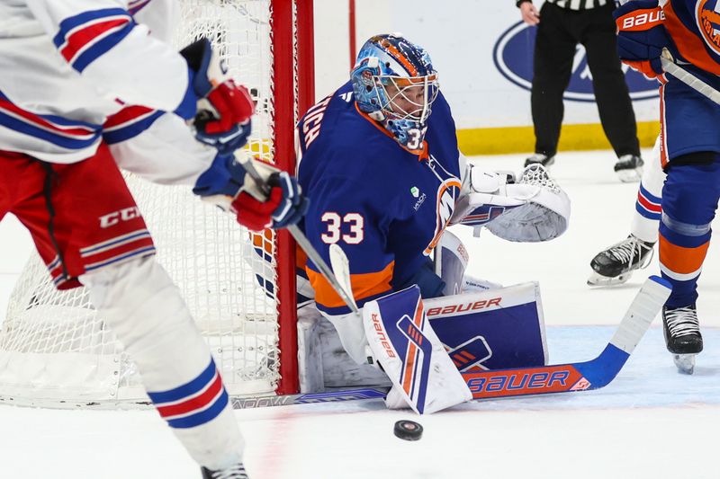 Dec 27, 2025; Elmont, New York, USA;  New York Islanders goaltender David Rittich (33) defends against a shot on goal attempt in the first period against the New York Rangers at UBS Arena. Mandatory Credit: Wendell Cruz-Imagn Images