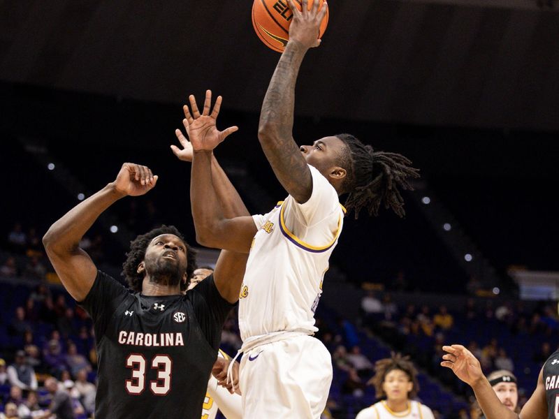 Feb 18, 2023; Baton Rouge, Louisiana, USA; LSU Tigers guard Cam Hayes (1) drives to the basket against South Carolina Gamecocks forward Josh Gray (33) at Pete Maravich Assembly Center. Mandatory Credit: Stephen Lew-USA TODAY Sports