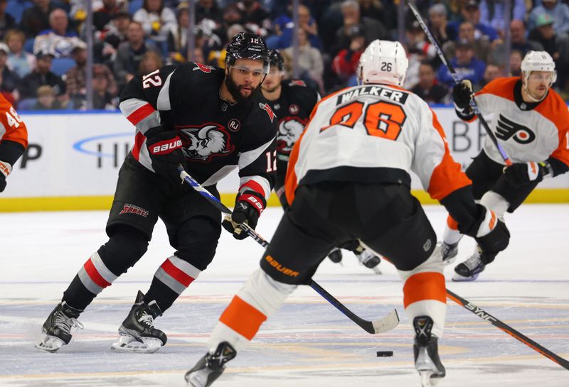 Nov 3, 2023; Buffalo, New York, USA;  Buffalo Sabres left wing Jordan Greenway (12) skates up ice with the puck as Philadelphia Flyers defenseman Sean Walker (26) looks to defend during the second period at KeyBank Center. Mandatory Credit: Timothy T. Ludwig-USA TODAY Sports