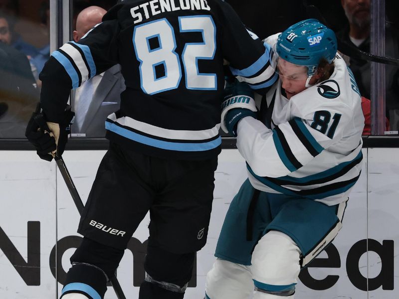 Oct 17, 2025; Salt Lake City, Utah, USA; Utah Mammoth center Kevin Stenlund (82) checks San Jose Sharks right wing Adam Gaudette (81) during the third period at Delta Center. Mandatory Credit: Rob Gray-Imagn Images