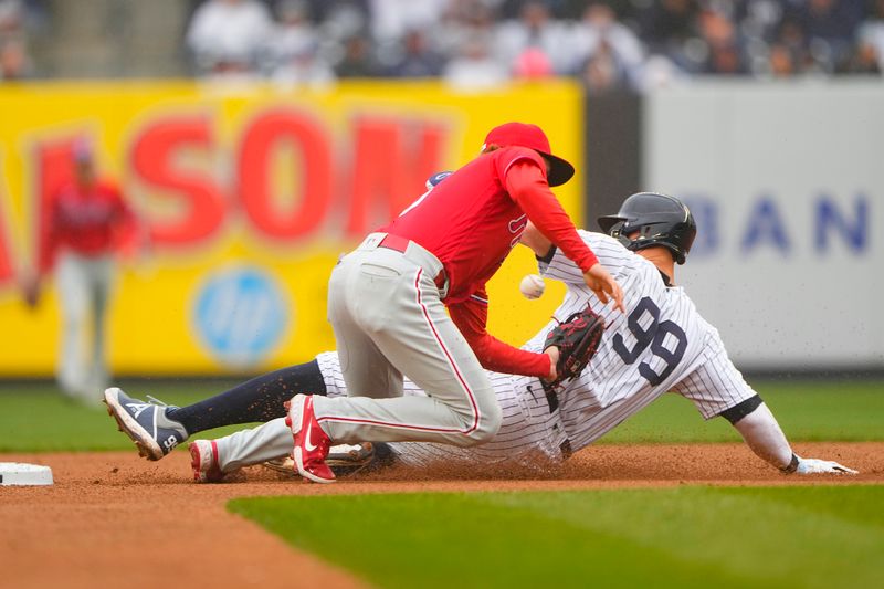 Apr 5, 2023; Bronx, New York, USA; New York Yankees center fielder Aaron Judge (99) steals second base with Philadelphia Phillies second baseman Bryson Stott (5) missing the throw during the first inning at Yankee Stadium. Mandatory Credit: Gregory Fisher-USA TODAY Sports