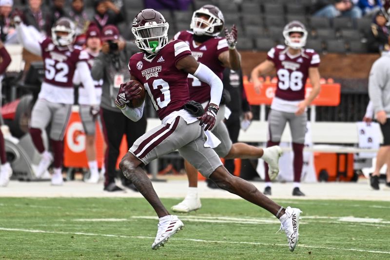 Nov 19, 2022; Starkville, Mississippi, USA; Mississippi State Bulldogs cornerback Emmanuel Forbes (13) returns an interception for a touchdown against the East Tennessee State Buccaneers during the second quarter at Davis Wade Stadium at Scott Field. Mandatory Credit: Matt Bush-USA TODAY Sports