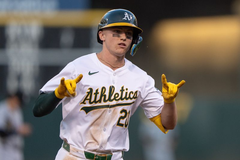 Aug 6, 2024; Oakland, California, USA;  Oakland Athletics second base Zack Gelof (20) reacts to the dugout after hitting a solo home run during the fourth inning against the Chicago White Sox at Oakland-Alameda County Coliseum. Mandatory Credit: Stan Szeto-USA TODAY Sports