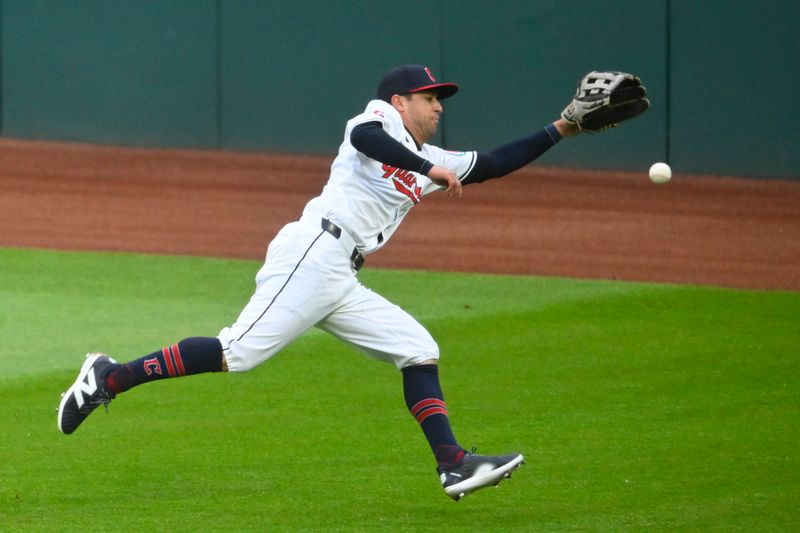 Apr 20, 2024; Cleveland, Ohio, USA; Cleveland Guardians center fielder Tyler Freeman (2) reaches for the ball in the fifth inning against the Oakland Athletics at Progressive Field. Mandatory Credit: David Richard-USA TODAY Sports