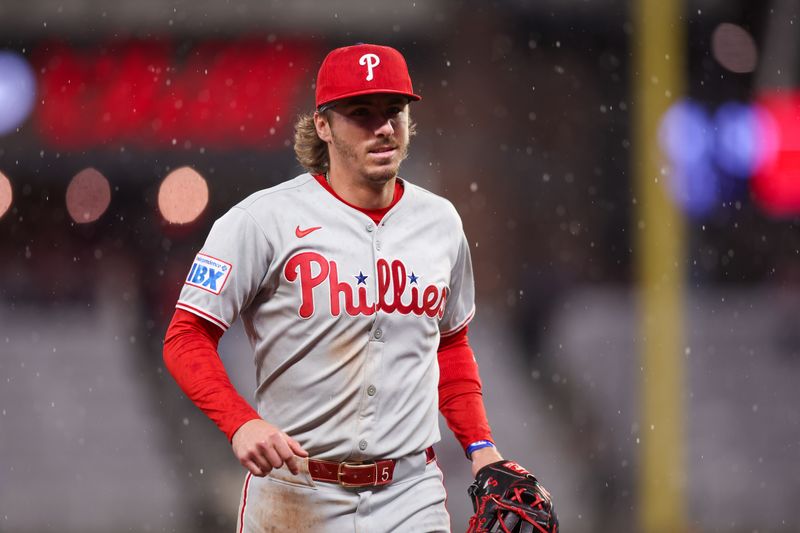 Apr 10, 2025; Atlanta, Georgia, USA; Philadelphia Phillies second baseman Bryson Stott (5) runs off the field in the rain against the Atlanta Braves in the sixth inning at Truist Park. Mandatory Credit: Brett Davis-Imagn Images