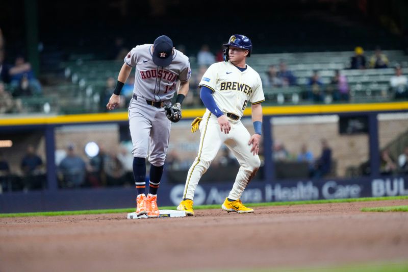 May 5, 2025; Milwaukee, Wisconsin, USA;  Milwaukee Brewers left fielder Isaac Collins (6) is tagged out by Houston Astros second baseman Mauricio Dubon (14)  while trying to steal second base during the first inning at American Family Field. Mandatory Credit: Jeff Hanisch-Imagn Images