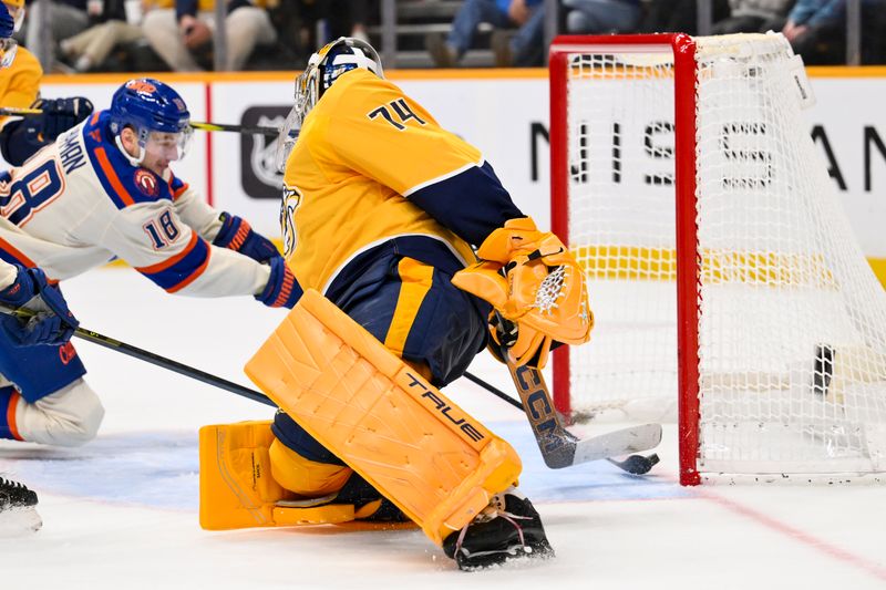 Jan 13, 2026; Nashville, Tennessee, USA;  Edmonton Oilers left wing Zach Hyman (18) scores past Nashville Predators goaltender Juuse Saros (74) during the second period at Bridgestone Arena. Mandatory Credit: Steve Roberts-Imagn Images