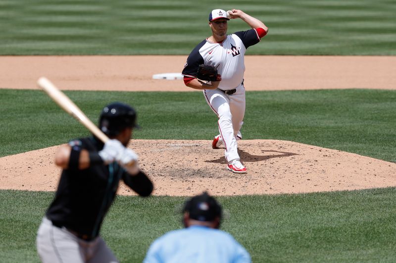 Jun 20, 2024; Washington, District of Columbia, USA; Washington Nationals relief pitcher Robert Garcia (61) pitches against Arizona Diamondbacks third baseman Eugenio Suárez (28) during the seventh inning at Nationals Park. Mandatory Credit: Geoff Burke-USA TODAY Sports