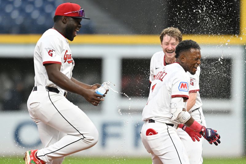 May 1, 2025; Cleveland, Ohio, USA; Cleveland Guardians center fielder Angel Martinez (1) celebrates with first baseman Kyle Manzardo (9) and right fielder Jhonkensy Noel, left, after hitting a game-winning RBI single during the tenth inning against the Minnesota Twins at Progressive Field. Mandatory Credit: Ken Blaze-Imagn Images


