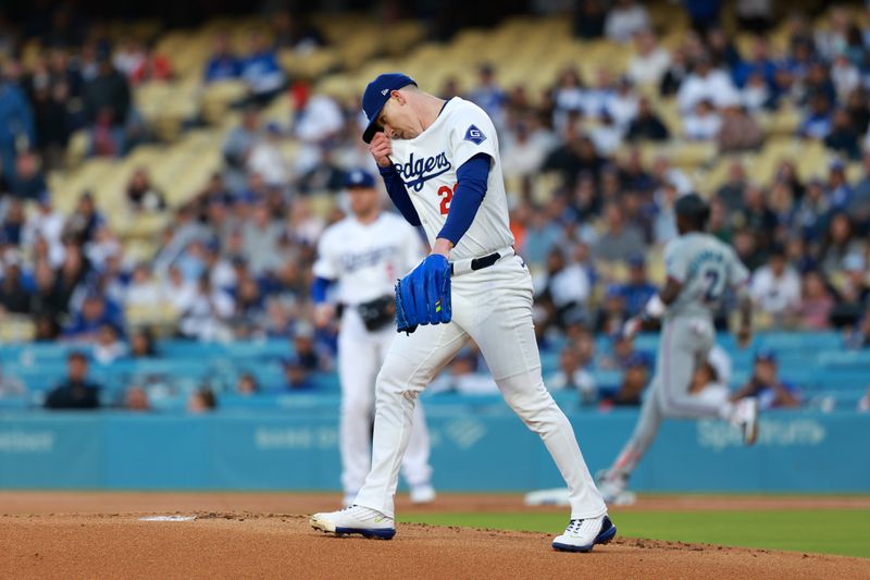 May 6, 2024; Los Angeles, California, USA;  Los Angeles Dodgers starting pitcher Walker Buehler (21) reacts after giving up a hit to Miami Marlins outfielder Jazz Chisholm Jr. (2) during the first inning at Dodger Stadium. Mandatory Credit: Kiyoshi Mio-USA TODAY Sports