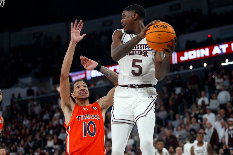 Jan 27, 2024; Starkville, Mississippi, USA; Mississippi State Bulldogs guard Shawn Jones Jr. (5) passes the ball as Auburn Tigers guard/forward Chad Baker-Mazara (10) defends2h\ at Humphrey Coliseum. Mandatory Credit: Petre Thomas-USA TODAY Sports